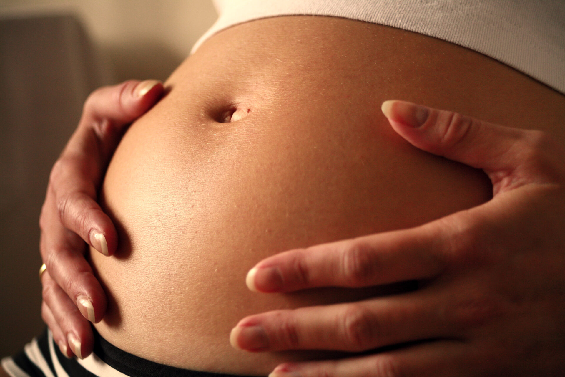 pregnant woman holding bump